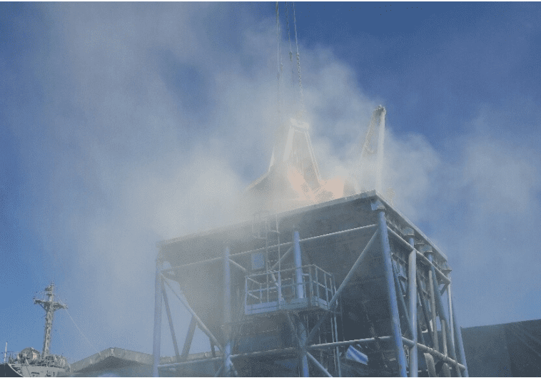 A space shuttle launches amidst smoke and flames from a metal tower structure against a clear blue sky.